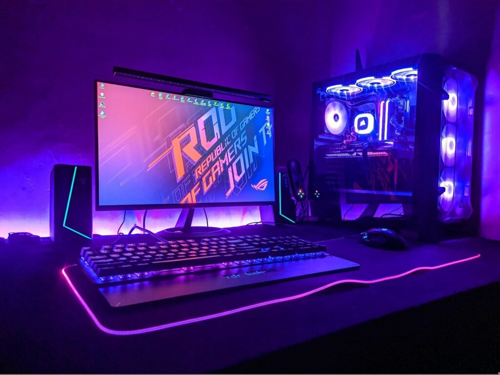 A gaming computer setup with a monitor, keyboard, and tower in purple