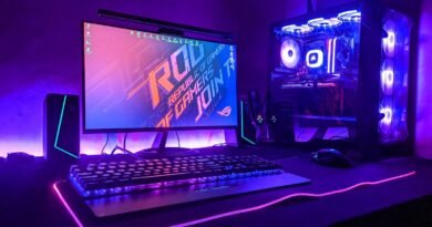 A gaming computer setup with a monitor, keyboard, and tower in purple