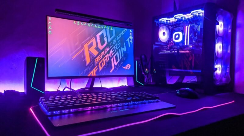 A gaming computer setup with a monitor, keyboard, and tower in purple