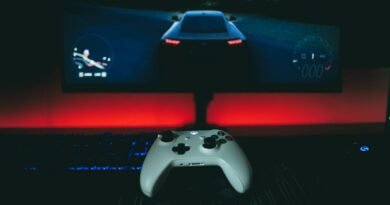 a video game controller sitting in front of a monitor