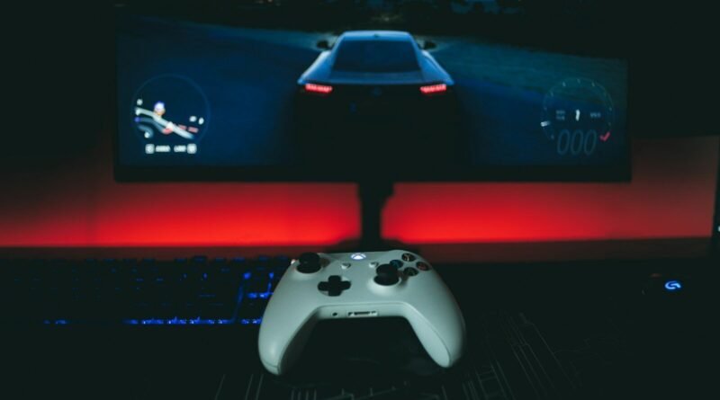a video game controller sitting in front of a monitor
